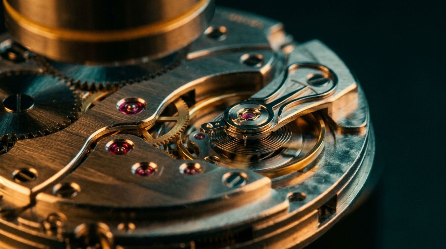 Macro photograph of a mechanical watch movement with ruby jewels under inspection light